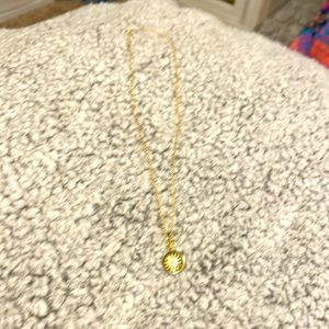 Gold necklace with silver charm